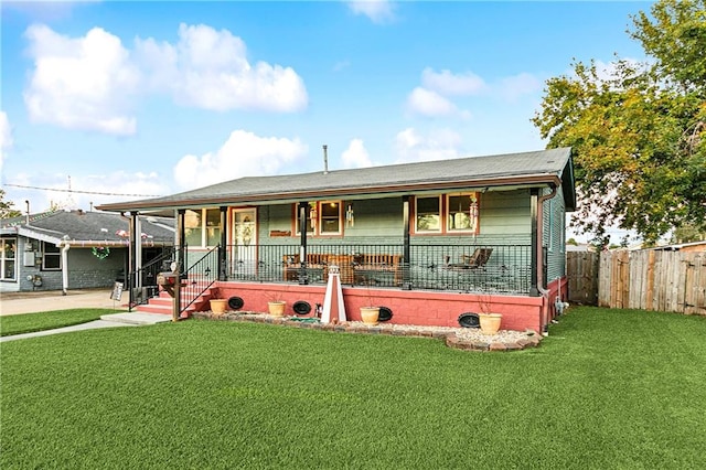 view of front of home with covered porch and a front lawn