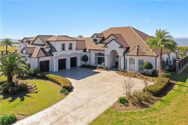 view of front of house with a front yard and a garage