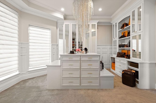 spacious closet with light colored carpet and a notable chandelier