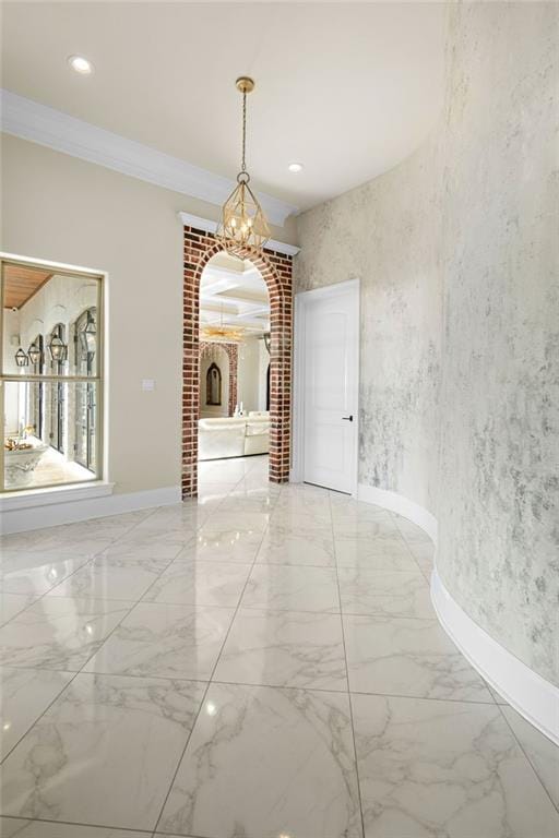 unfurnished dining area with ornamental molding and a chandelier