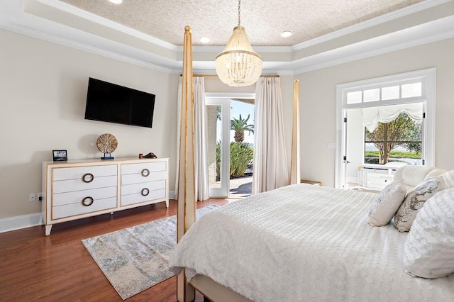 bedroom with a raised ceiling, dark hardwood / wood-style floors, access to exterior, and ornamental molding