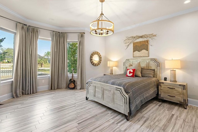 bedroom featuring light hardwood / wood-style flooring, a notable chandelier, and crown molding