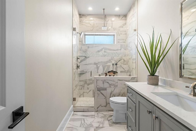 bathroom with vanity, toilet, and a shower with door