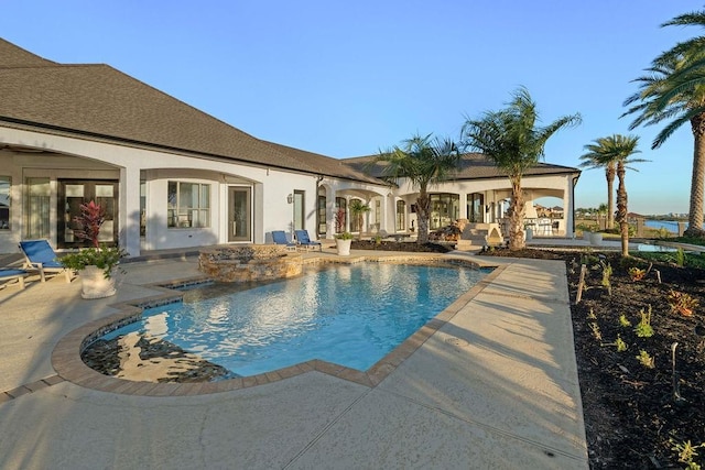 view of swimming pool with a patio and a hot tub