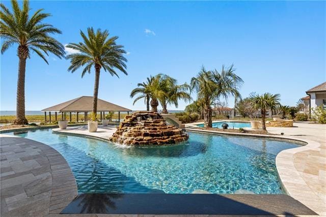 view of pool featuring pool water feature and a gazebo