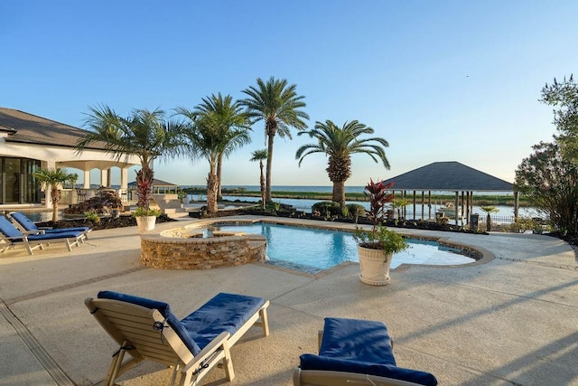 view of swimming pool featuring a gazebo, a patio area, a water view, and an in ground hot tub