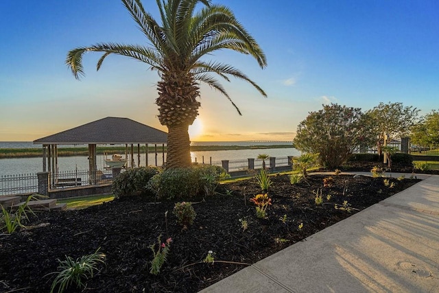 exterior space featuring a gazebo and a water view