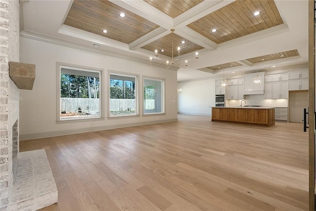 unfurnished living room featuring wood ceiling, a fireplace, baseboards, and light wood-style flooring