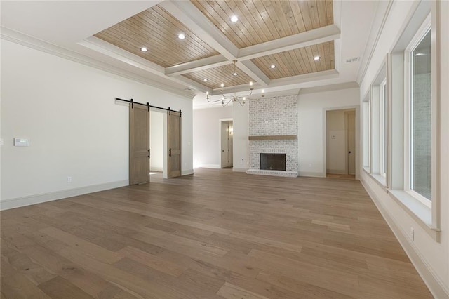 unfurnished living room featuring a barn door, wood finished floors, wooden ceiling, coffered ceiling, and baseboards