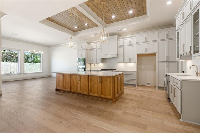 living room with coffered ceiling, sink, beamed ceiling, light hardwood / wood-style floors, and wood ceiling