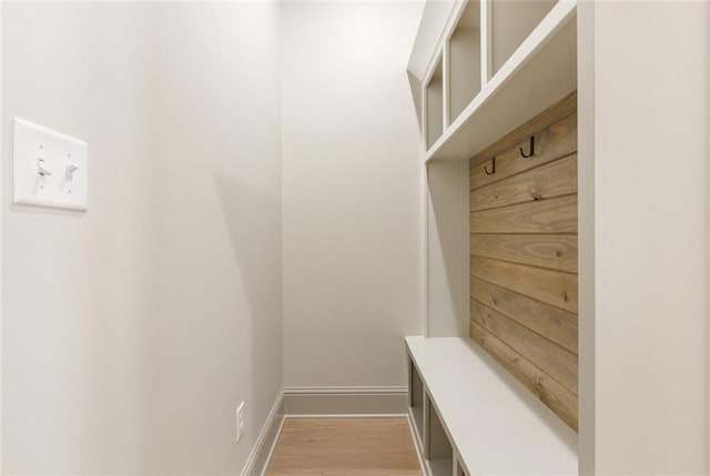 mudroom with baseboards and wood finished floors