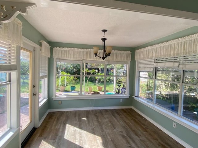 unfurnished sunroom with a chandelier