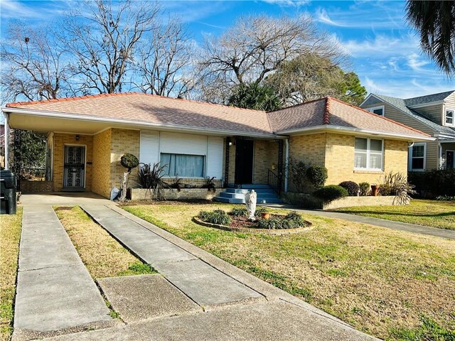 ranch-style home with a front yard and a carport