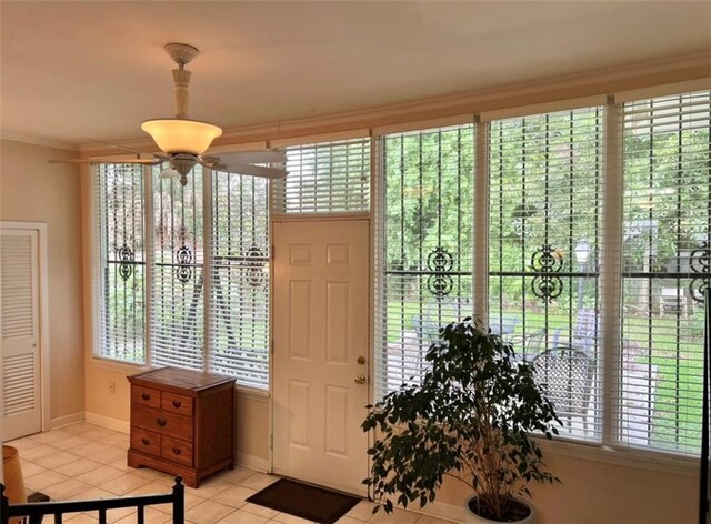 foyer entrance featuring ornamental molding and light tile patterned floors