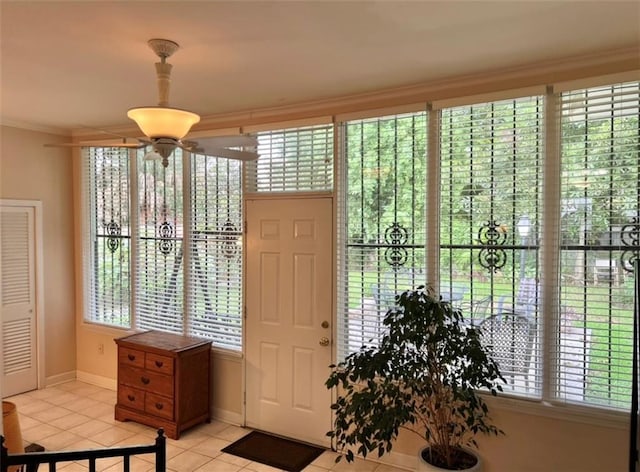 tiled foyer featuring ornamental molding