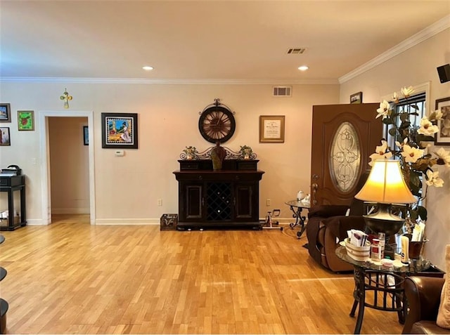 interior space with ornamental molding and light wood-type flooring