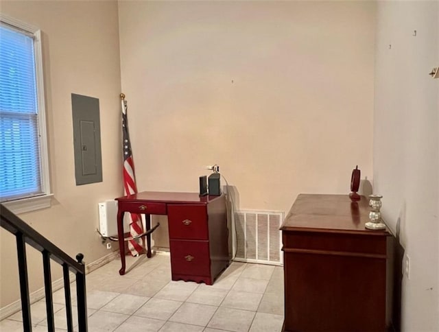 home office with light tile patterned floors and electric panel