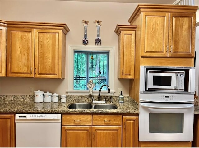 kitchen featuring white appliances and sink