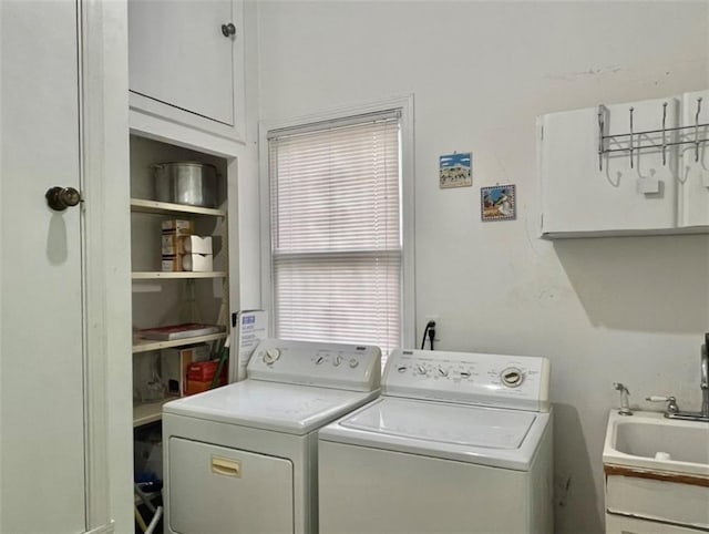 clothes washing area featuring separate washer and dryer and sink