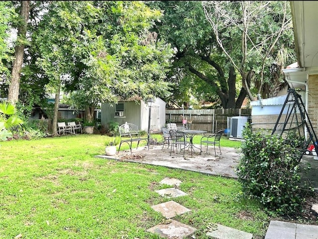 view of yard featuring a storage shed, a patio, and central air condition unit