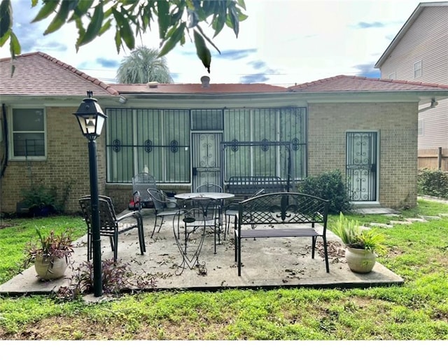 back of house with a yard and a patio area