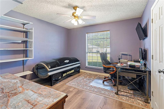 office with wood-type flooring, a textured ceiling, and ceiling fan