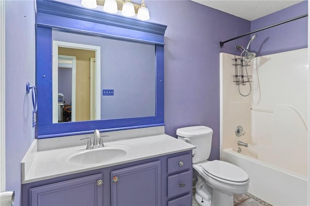 full bathroom featuring toilet, vanity, a textured ceiling, and tub / shower combination