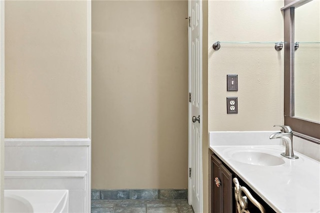 bathroom with a bathing tub and vanity