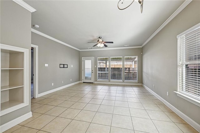 tiled empty room with ceiling fan and ornamental molding
