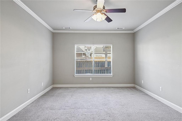 carpeted empty room with ceiling fan and crown molding