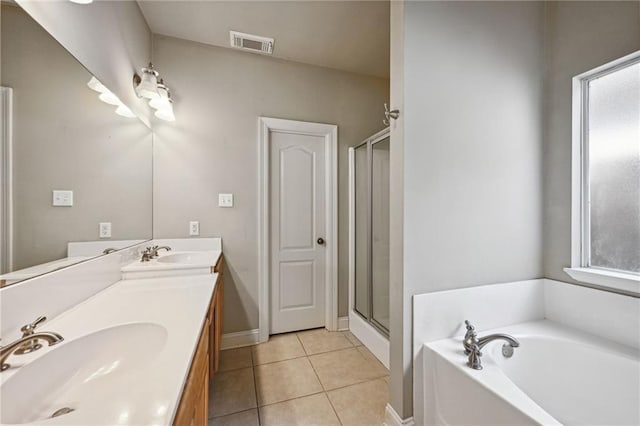 bathroom featuring tile patterned flooring, vanity, and plus walk in shower
