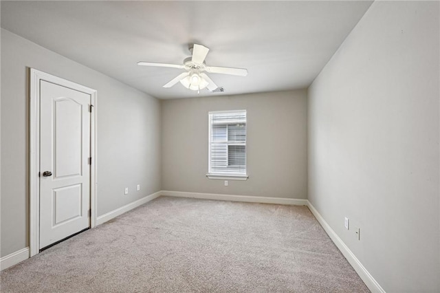 empty room with ceiling fan and light colored carpet