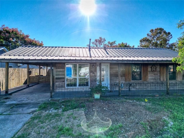 361 Helis Dr, Westwego, LA 70094 - view of front facade with a carport, metal roof, and concrete driveway