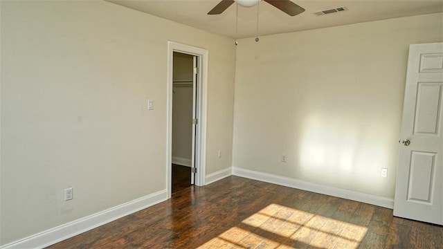 spare room with dark hardwood / wood-style floors and ceiling fan