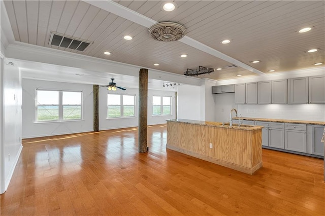 kitchen with wooden ceiling, light hardwood / wood-style flooring, ceiling fan, gray cabinets, and ornamental molding