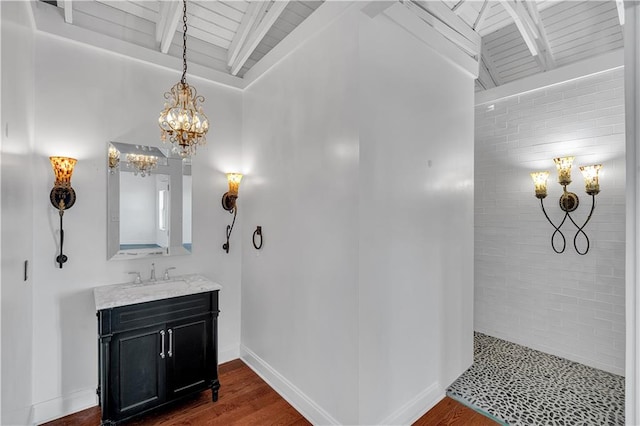 bathroom featuring wood-type flooring, vanity, an inviting chandelier, and wood ceiling