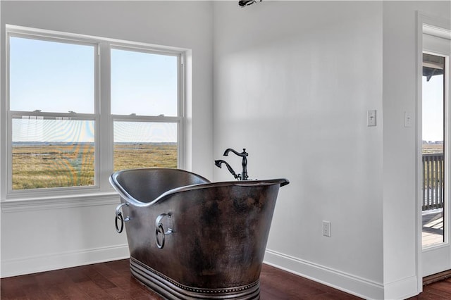 sitting room featuring plenty of natural light and dark hardwood / wood-style flooring