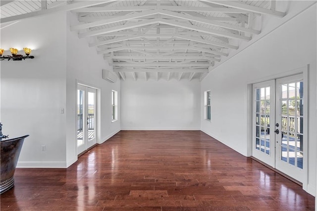 interior space featuring french doors, dark wood-type flooring, beam ceiling, an AC wall unit, and high vaulted ceiling