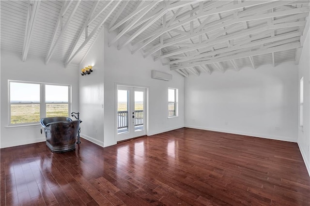 unfurnished living room featuring dark hardwood / wood-style flooring, a wealth of natural light, and french doors