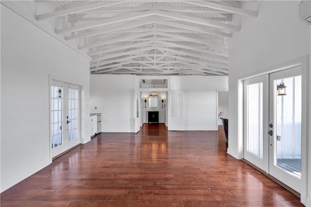 interior space featuring a wall mounted air conditioner, french doors, dark hardwood / wood-style flooring, high vaulted ceiling, and beamed ceiling