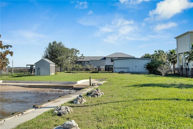 view of yard with a water view and a storage unit