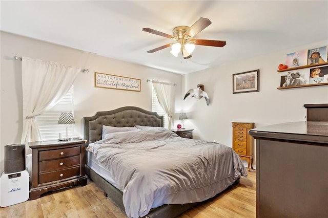 bedroom with ceiling fan and light hardwood / wood-style flooring