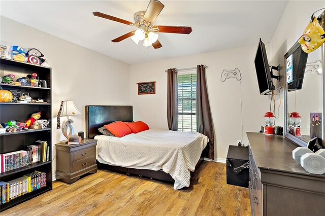 bedroom with ceiling fan and light hardwood / wood-style flooring