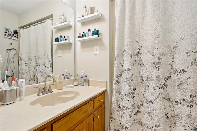 bathroom with curtained shower and vanity