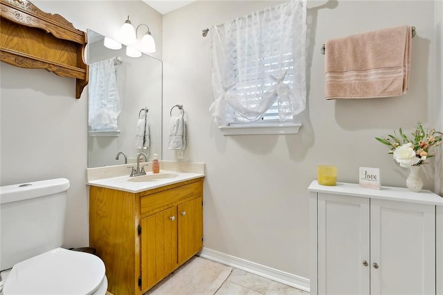 bathroom featuring tile patterned flooring, vanity, and toilet