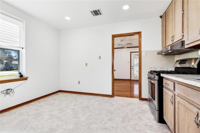 kitchen featuring light brown cabinetry and stainless steel gas range