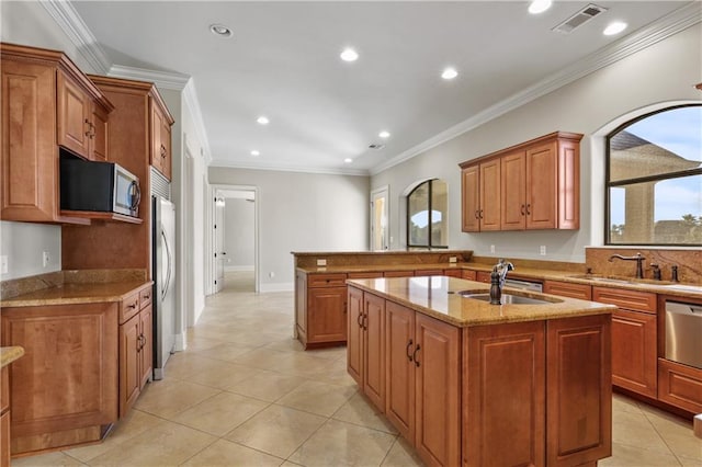 kitchen featuring a center island with sink, crown molding, sink, light stone counters, and stainless steel appliances