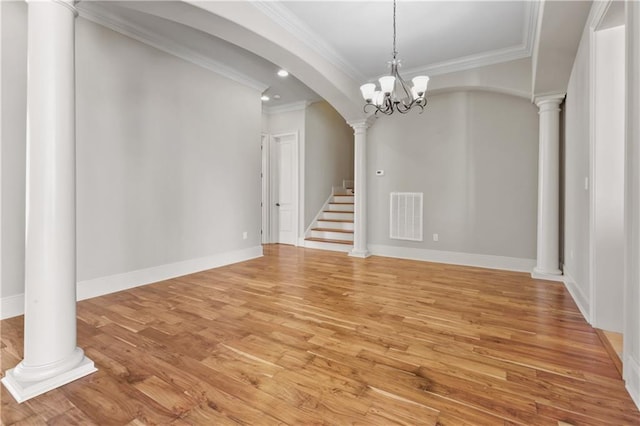 interior space with a chandelier, crown molding, and light hardwood / wood-style floors