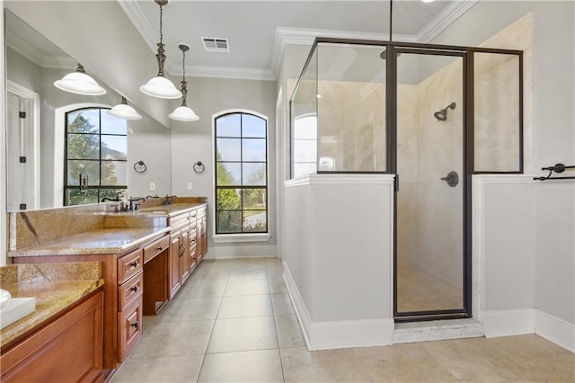 bathroom featuring vanity, a healthy amount of sunlight, and ornamental molding