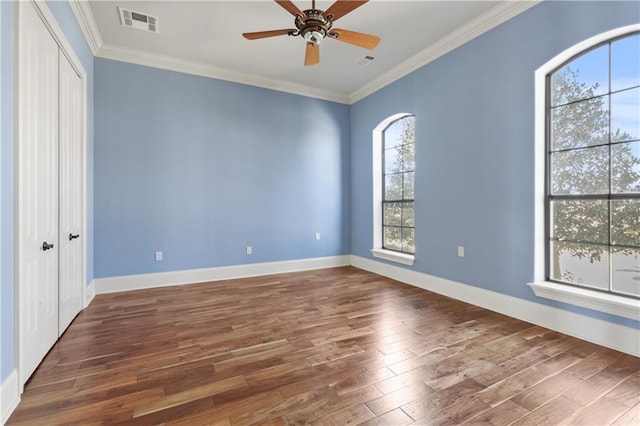 unfurnished room with dark hardwood / wood-style floors, ceiling fan, and crown molding